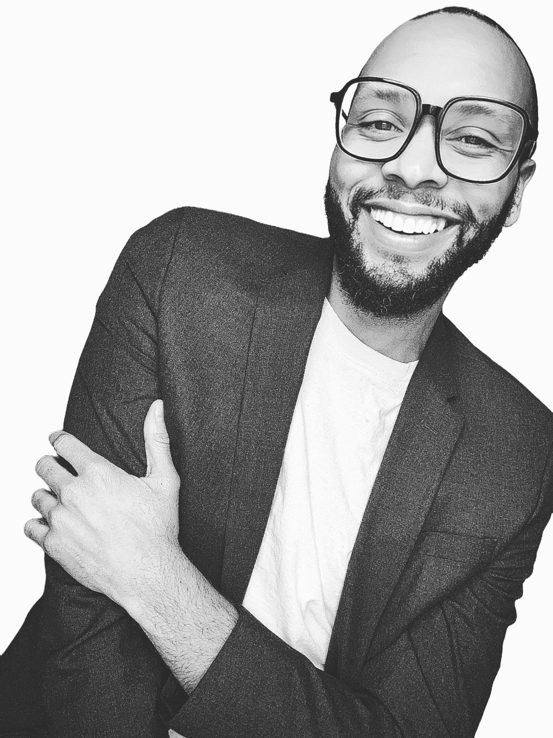 Landon Alexander, Black and white photo, t-shirt and blazer, smiling, trustworthy, learning and development professional.